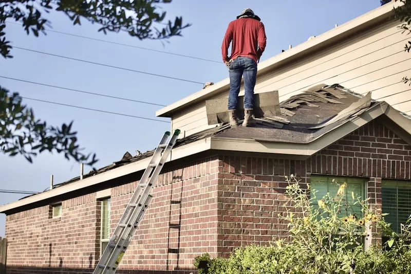 Professional roofer working on a residential roof in Westmont